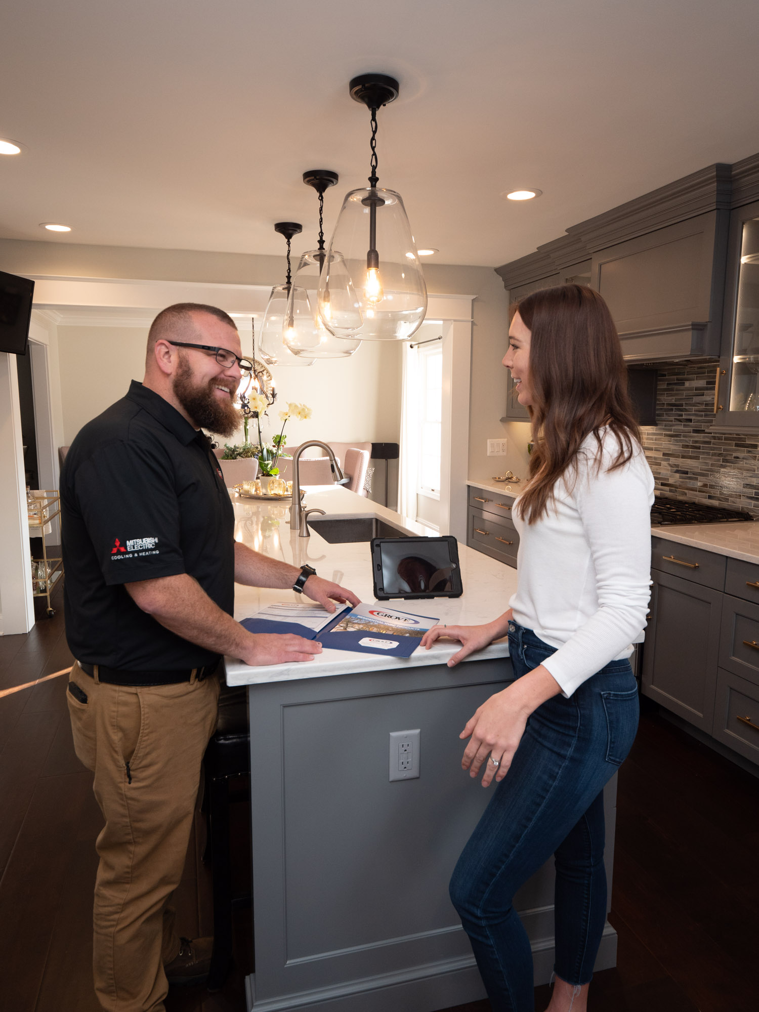 A technician helping a woman How to Troubleshoot Your AC Unit Before Calling an AC Repair Company in Arnold